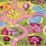 Close-up of a pink and green village map carpet with a kitten plush toy