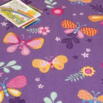 Close-up of butterfly play carpet with a sketch pad.