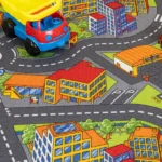 Close-up of kids' city road carpet with a toy truck.