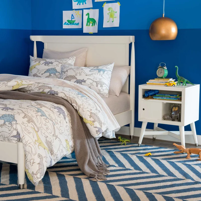 Kids' bedroom with a blue and white chevron pattern carpet.