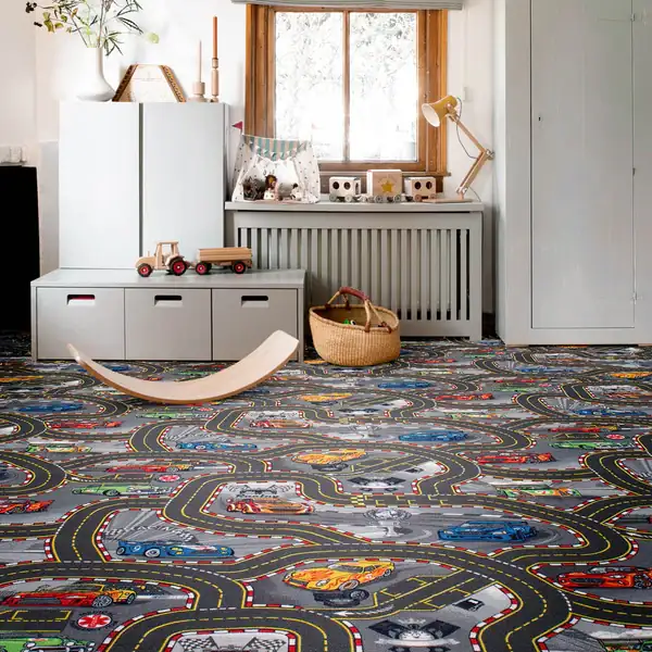 Kids' playroom with a racing track road map carpet.