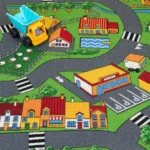 Kids' village road carpet with houses and toy truck.