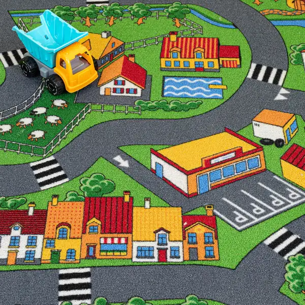 Kids' village road carpet with houses and toy truck.