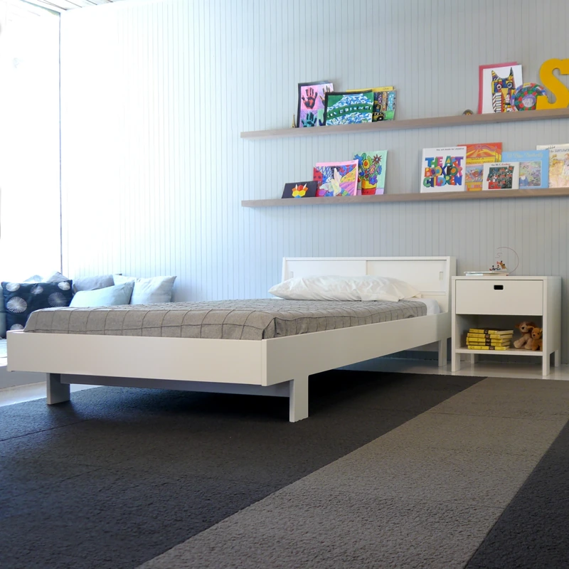 Minimalist grey striped carpet in a modern children's bedroom.