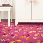 Pink kids' carpet with colorful butterflies and flowers.