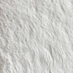 Close-up texture of soft cream fluffy faux fur carpet