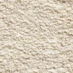Close-up texture of soft cream plush carpet pile fabric