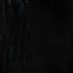 Dark black faux fur texture background with subtle shine