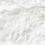 Fluffy white faux fur rug material macro texture view.