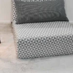 Geometric patterned chair on soft fluffy rug with lamps