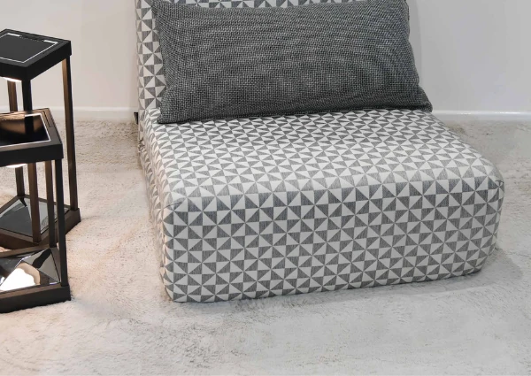 Geometric patterned chair on soft fluffy rug with lamps