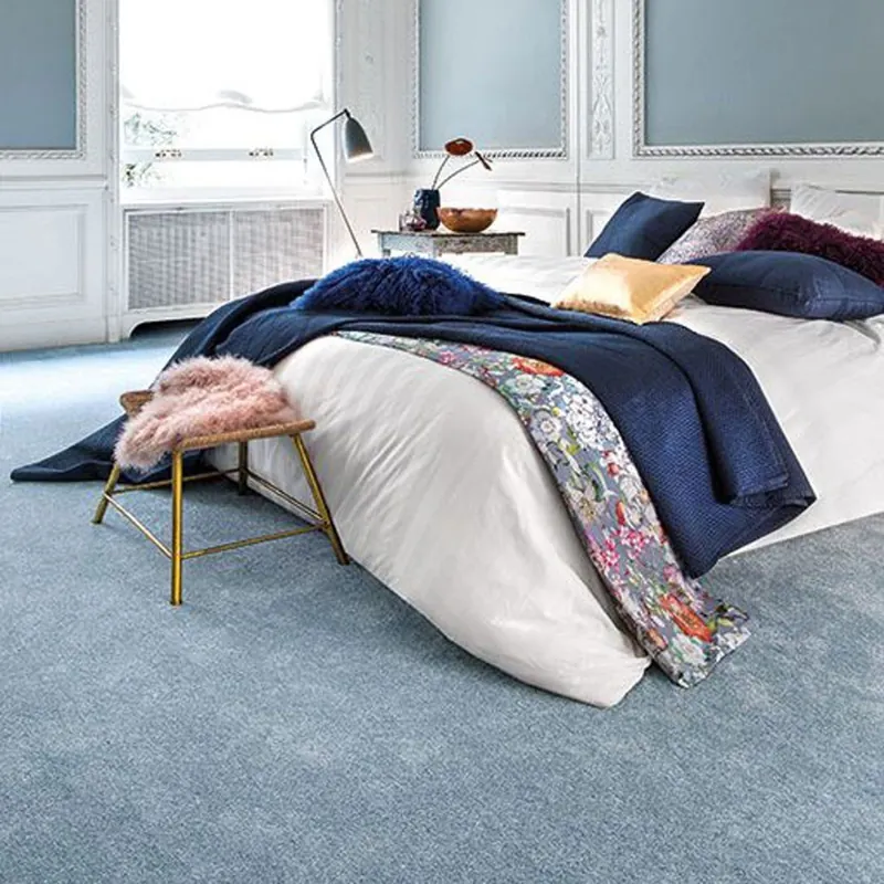 Soft dusty blue wall-to-wall carpet in luxury bedroom